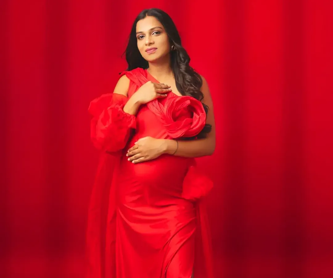 Embrace your power and passion in this stunning red gown. Featuring bold floral shoulder details and a graceful flow, this dress is designed for the mom-to-be who wants to make a vibrant and confident statement.