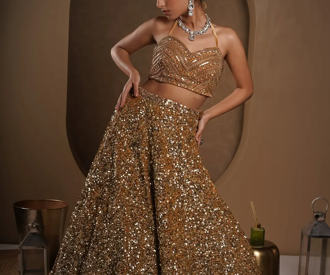 A full-length shot of a stunning sequined lehenga. My goal here was to capture the way the garment glitters under studio lights while showcasing its elegant silhouette and the model's graceful pose for a designer lookbook.
