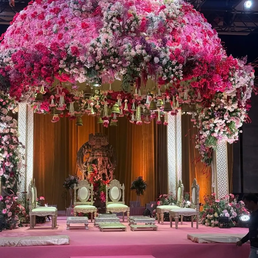 This wedding mandap was a dream brought to life, a blossoming dome of countless pink and white florals creating a sacred canopy. The sheer scale and density of the flowers were designed to envelop the couple in an atmosphere of pure romance, making their sacred vows feel like a moment suspended in a floral heaven.