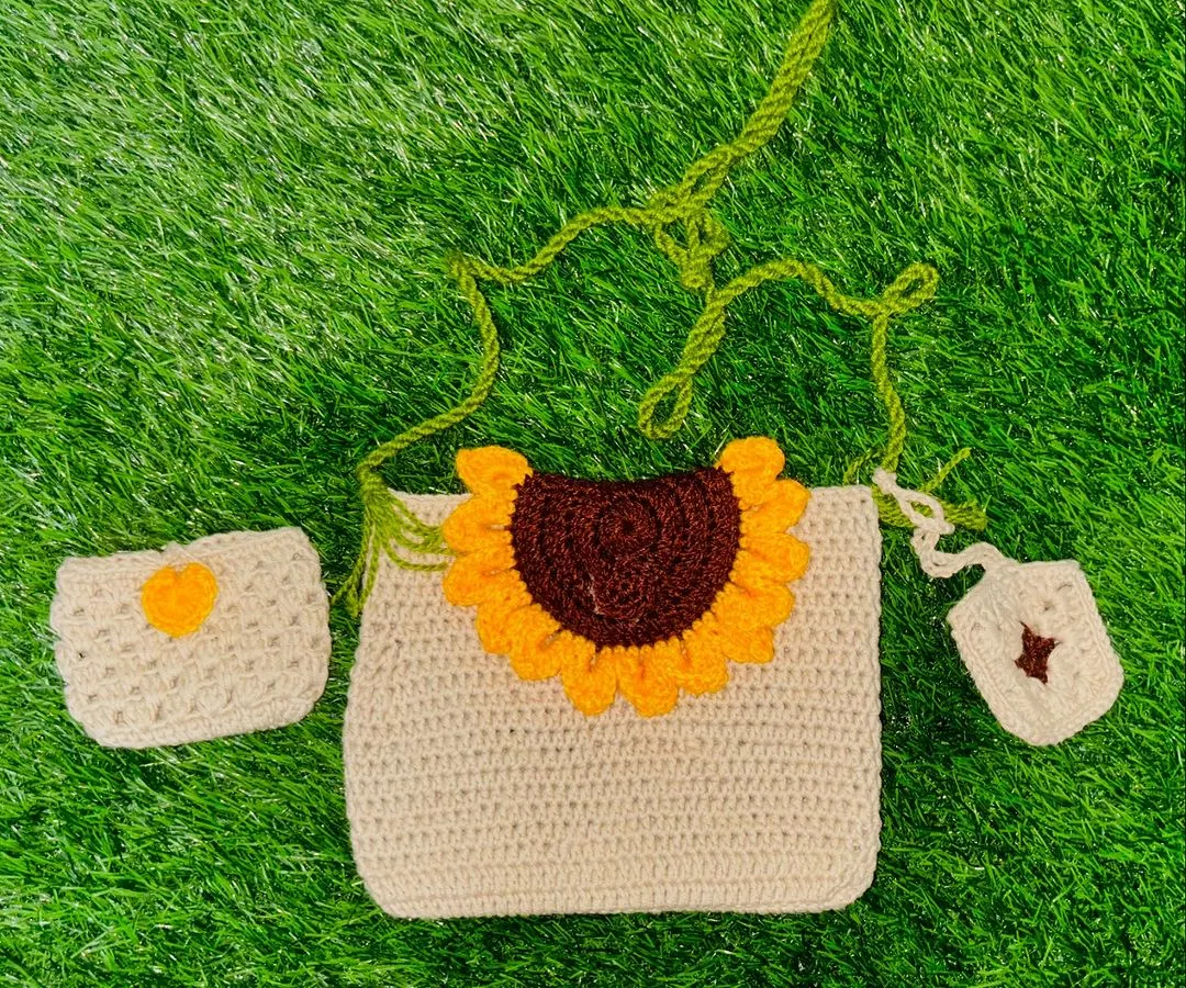 My signature crochet sunflower sling bag set. This three-piece combo includes the main bag, a matching small pouch, and a tiny charm, all handcrafted with durable yarn.