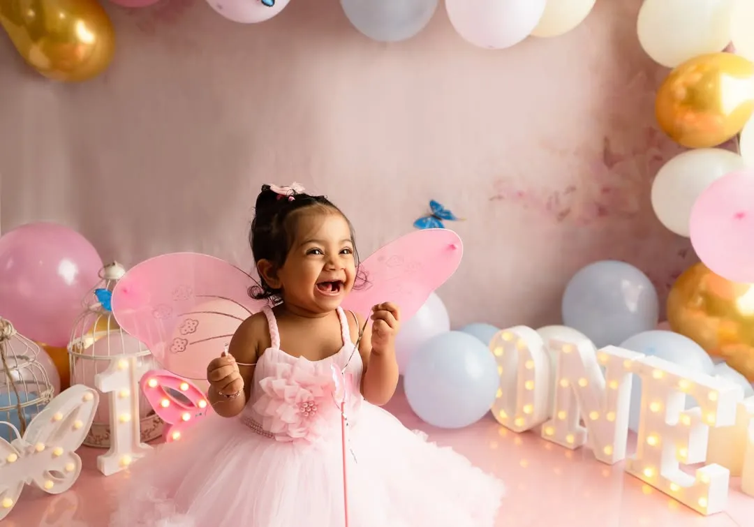 Capturing the pure, uninhibited joy of a first birthday cake smash. This butterfly themed session was designed to be fun and memorable, resulting in genuine laughter and beautiful photographs that celebrate this special milestone.