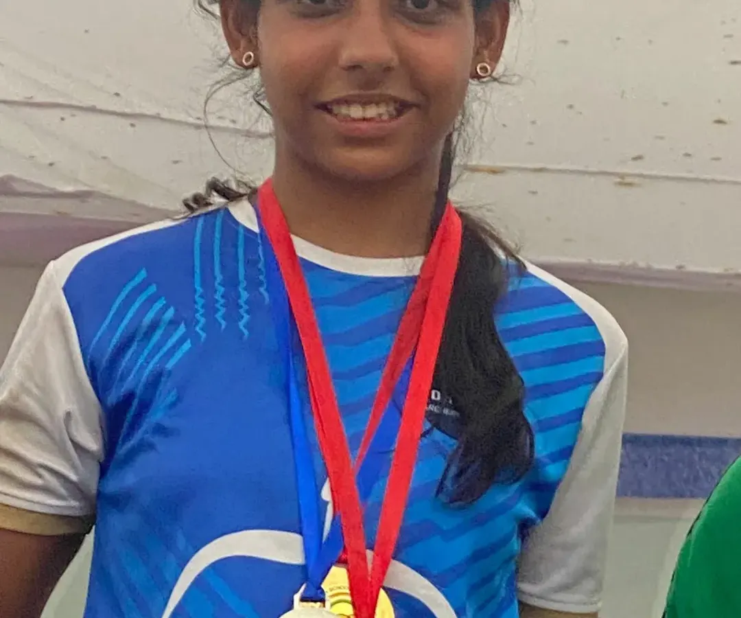 The result of dedication and disciplined practice. Here, one of my students proudly displays her collection of medals, showcasing her achievements in competitive archery.