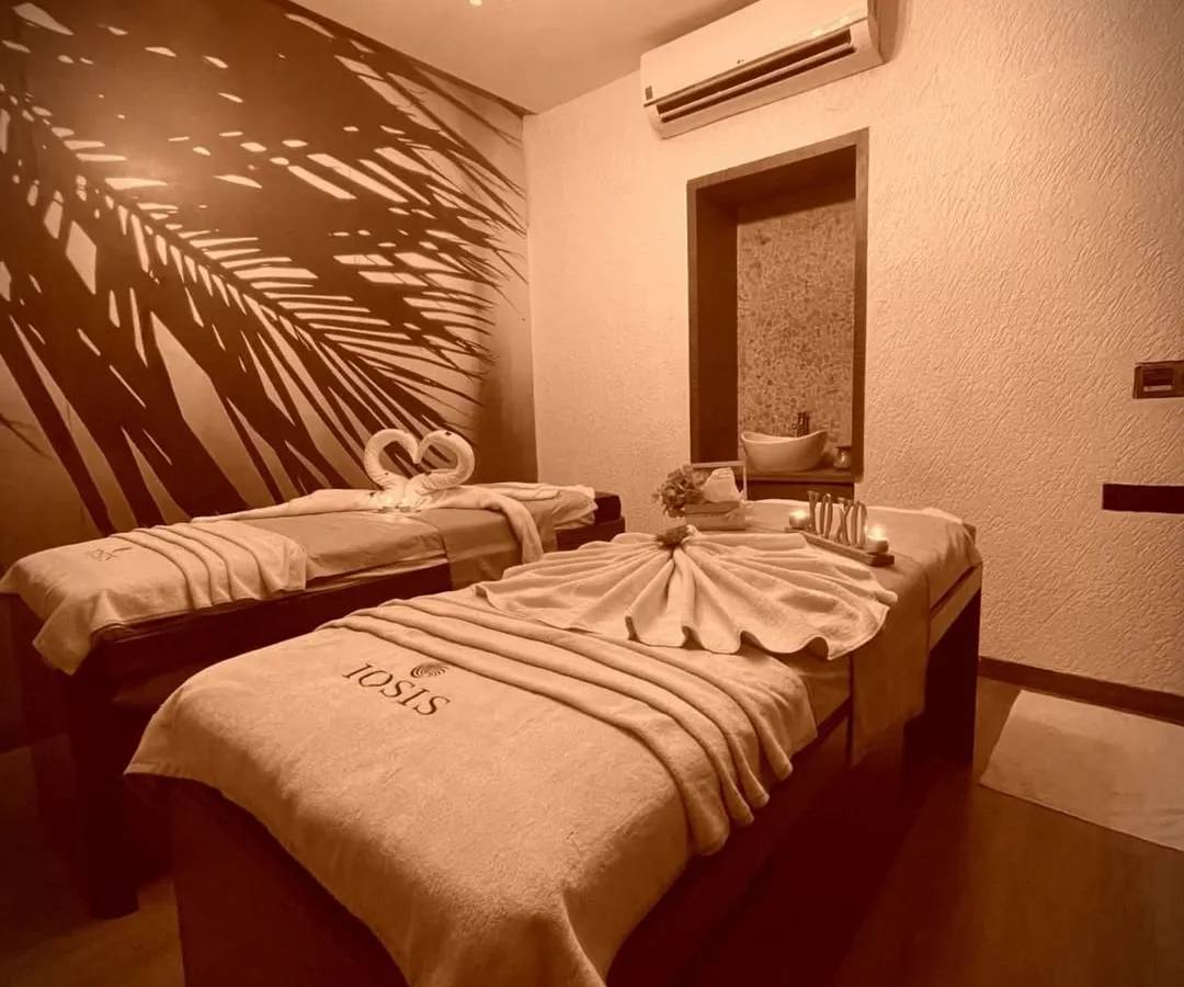 Welcome to your personal sanctuary. I've designed my treatment rooms to be a haven of peace and luxury, where you can truly disconnect. Notice the serene lighting, the plush, branded linens, and the elegant decor, all set for your complete relaxation.