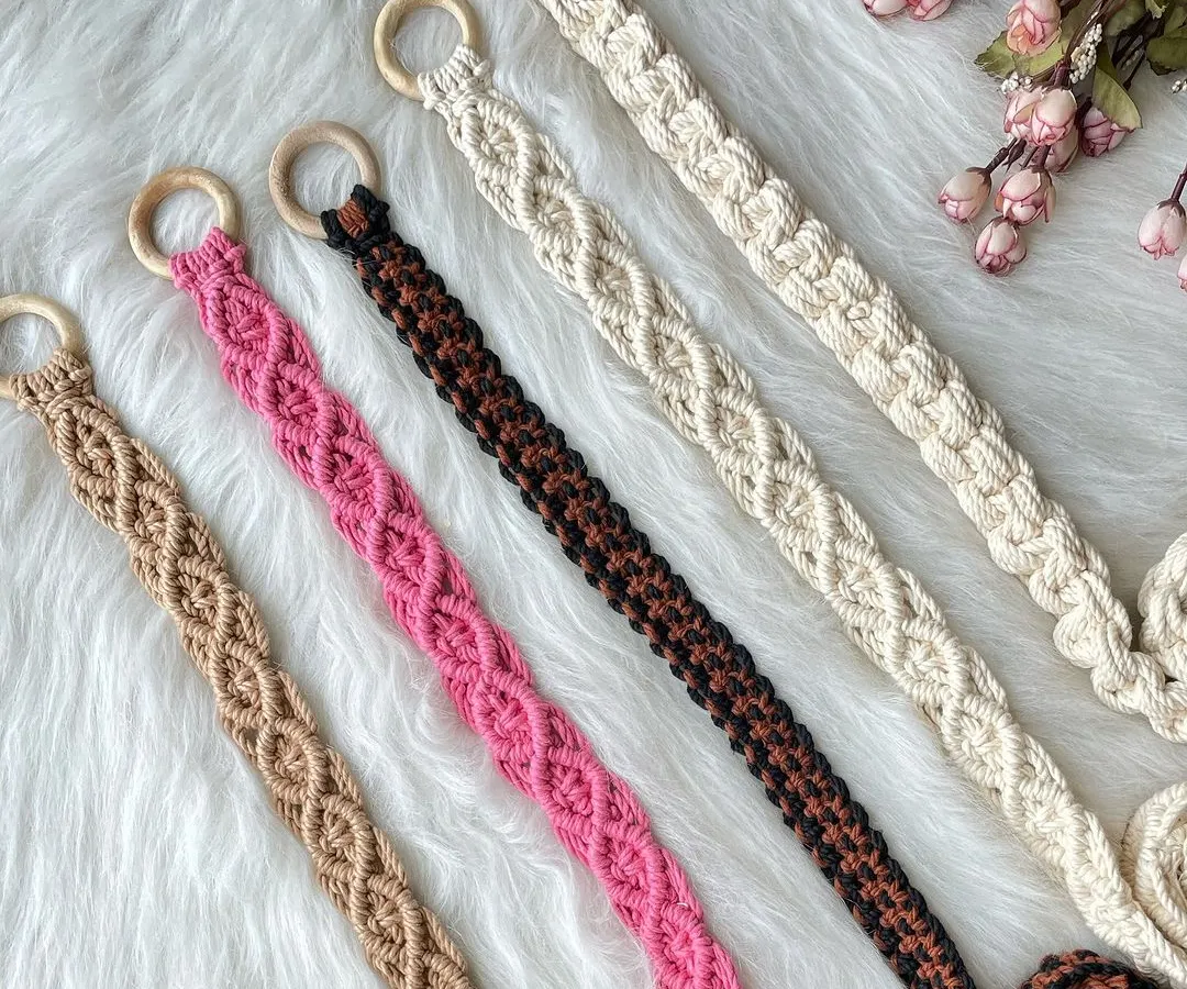 My handmade macrame belts, perfect for adding a bohemian touch to any outfit. Pictured here are five different color options, from neutral off-white and earthy brown to bold pink, each featuring a beautiful knotted pattern and a smooth wooden ring buckle. I can customize the size and color for a perfect fit.
