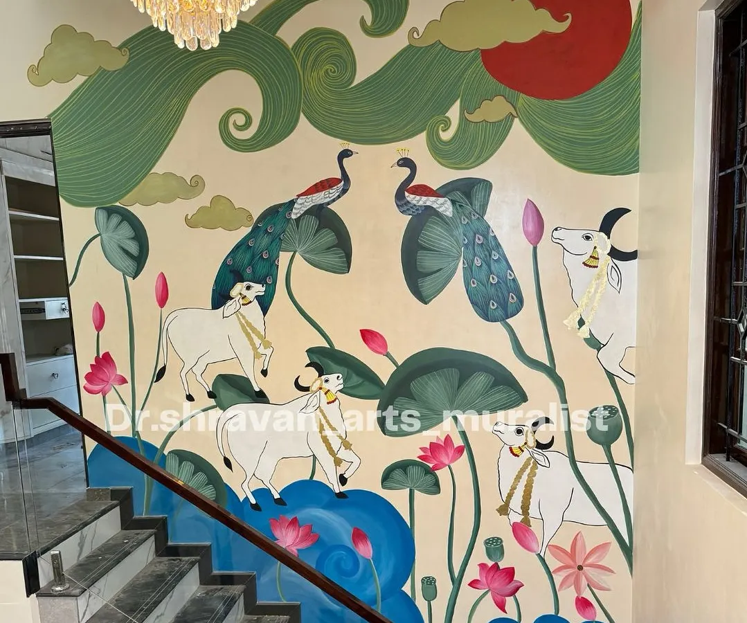 I love bringing our heritage to life on a grand scale. This expansive Pichwai mural flows up a staircase, filling the home with traditional elegance, featuring sacred cows, peacocks, and lotus ponds. Each element is hand-painted to tell a story of culture and beauty.