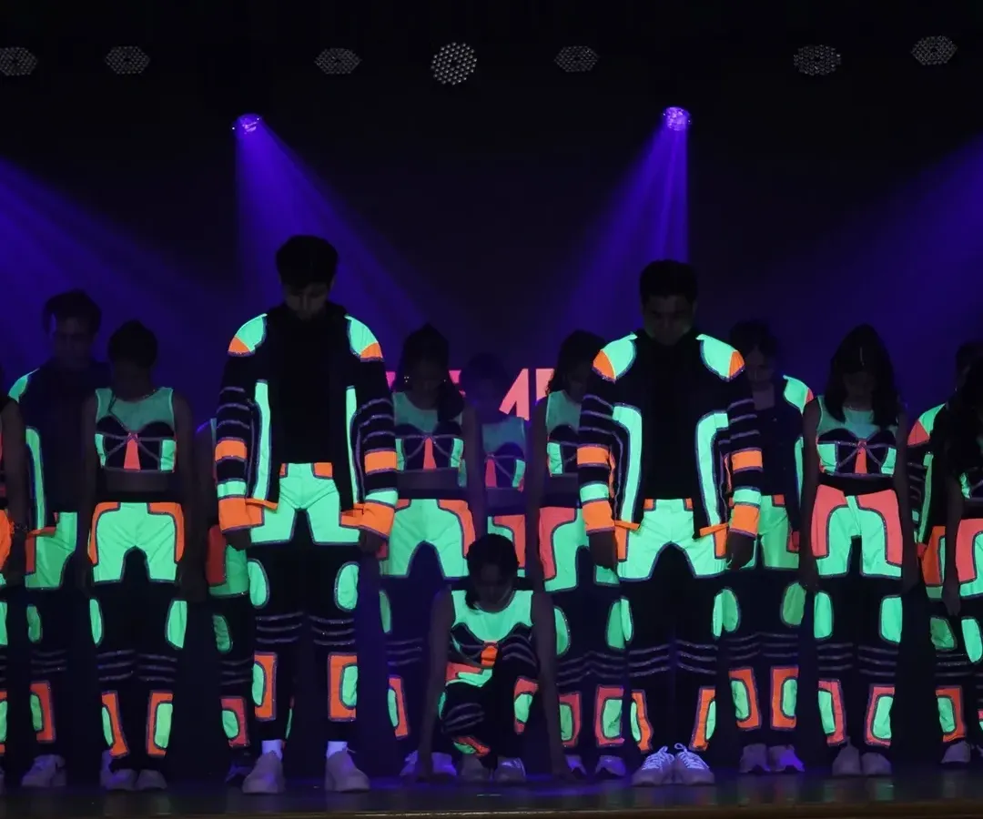 We love getting creative with our performances. This glow-in-the-dark hip hop routine was a huge hit, combining cool choreography with stunning visual effects to create a truly memorable stage act.