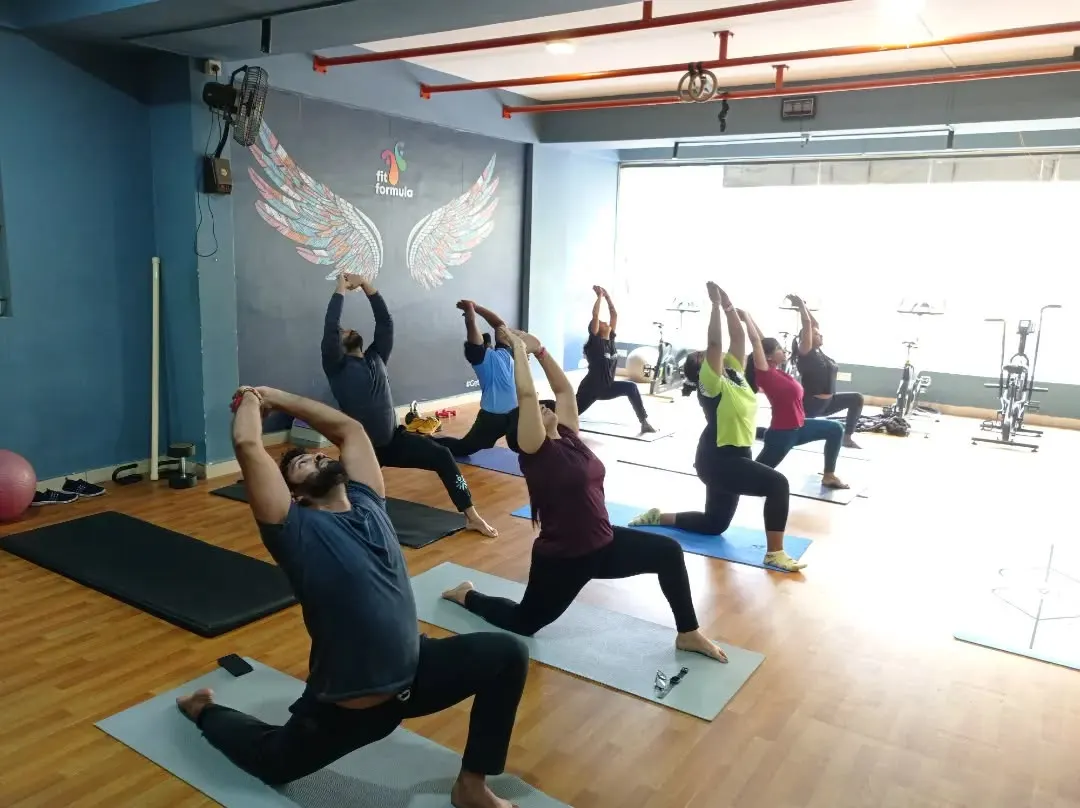 Our group yoga sessions are all about finding strength and alignment together. Here, we're moving through Anjaneyasana, a great pose for opening up the hips. Even in a group, we make sure everyone's form is on point.