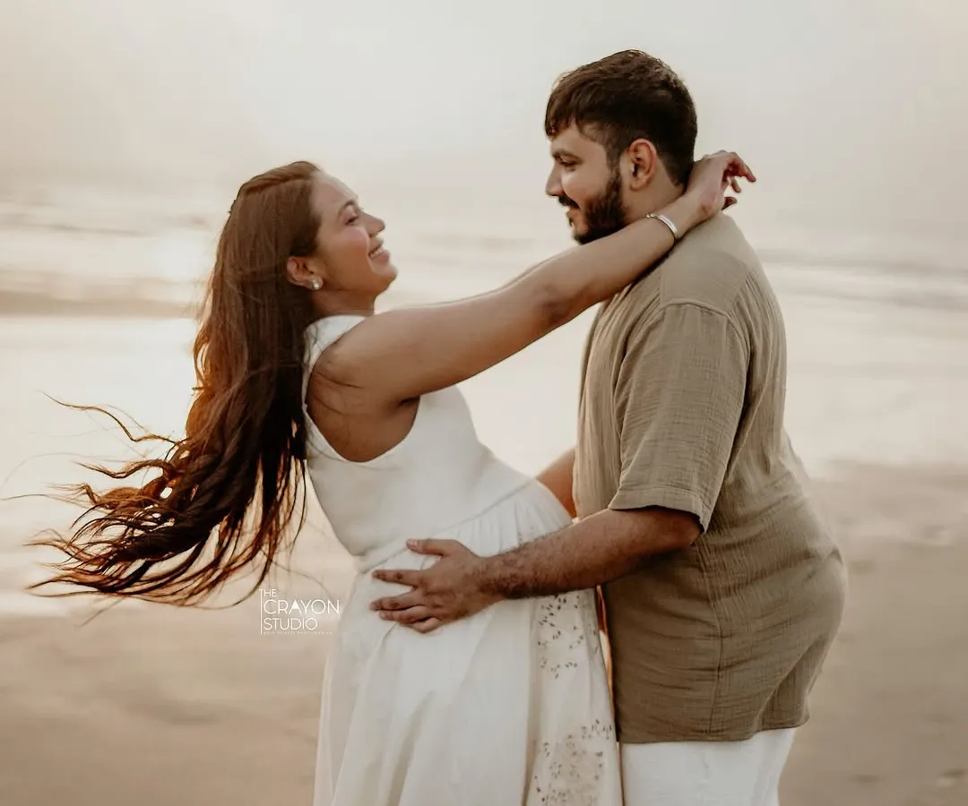 An outdoor maternity shoot on the beach is all about capturing pure, uninhibited joy. I love these moments of laughter and connection, where you can almost feel the sea breeze and the warmth of their love.