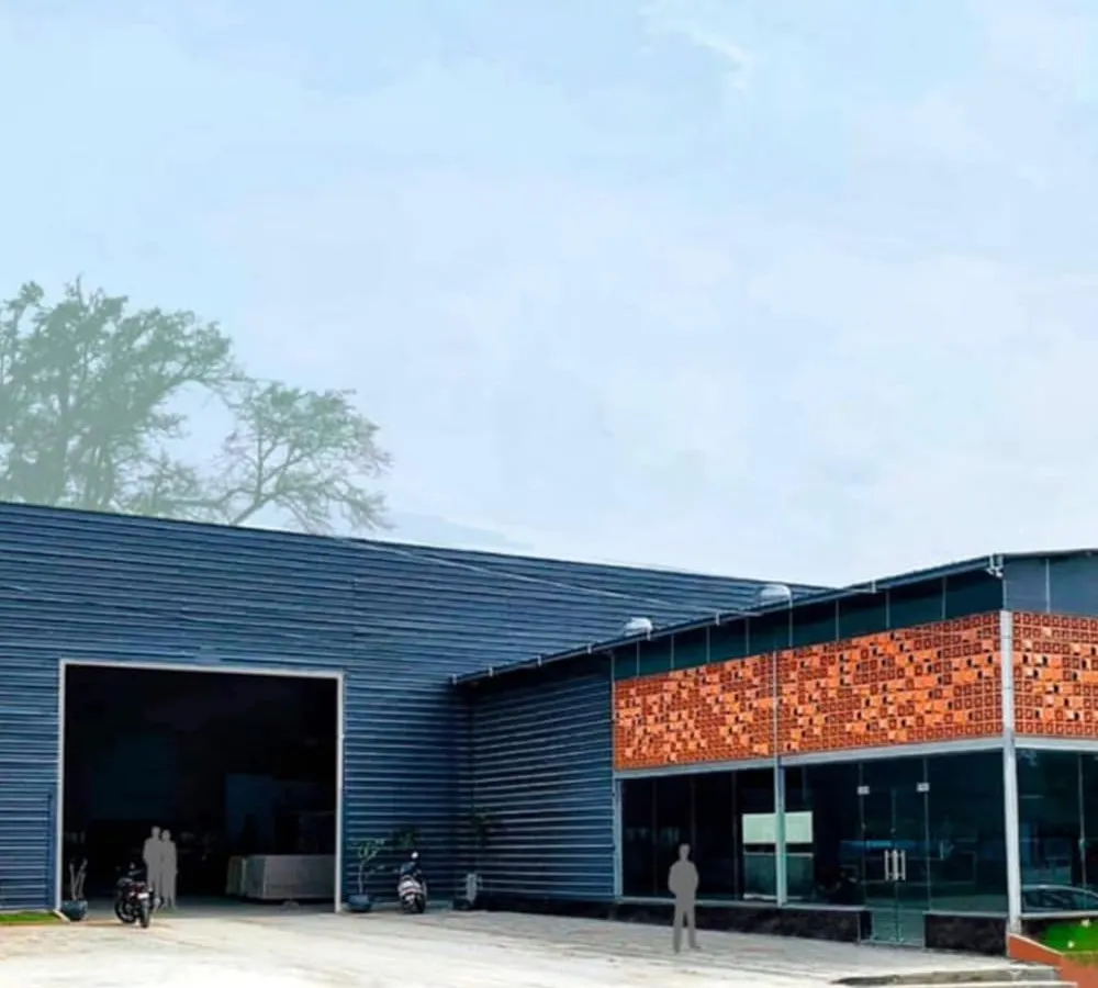 The completed facade of the Om Marble Warehouse in Bangalore. This project demonstrates our ability to create striking commercial buildings that balance industrial functionality with a strong aesthetic identity, using materials like metal cladding and terracotta.