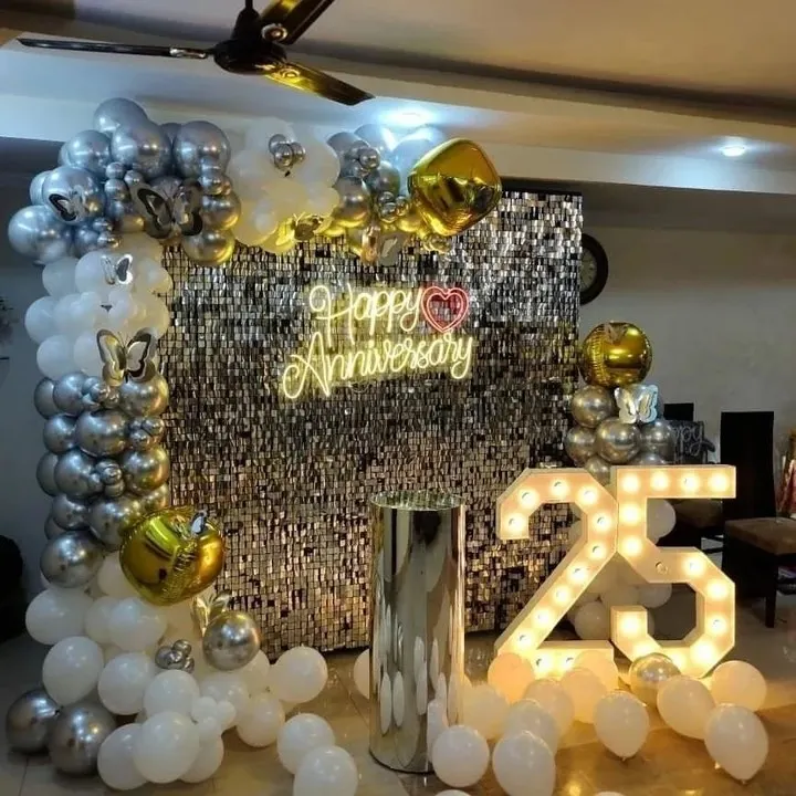 Celebrating a 25th anniversary with a glamorous silver sequin backdrop, a custom neon sign, and large marquee numbers. This elegant setup is perfect for major company milestones and creates a fantastic photo opportunity.
