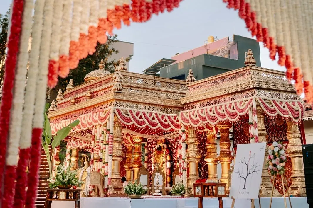 This is tradition with the volume turned all the way up. We designed this opulent temple-style mandap to feel like a sacred monument, using intricate golden pillars and dramatic floral arrangements for a truly royal muhurtham.