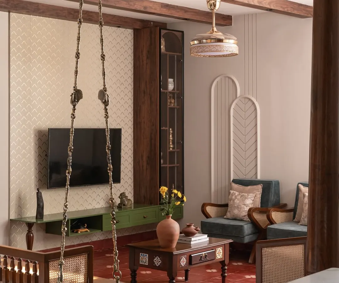 For this living room, I blended traditional Indian aesthetics with contemporary design. The space features antique wooden pillars, a classic swing, and rich textures to create a home that feels both rooted and innovative.