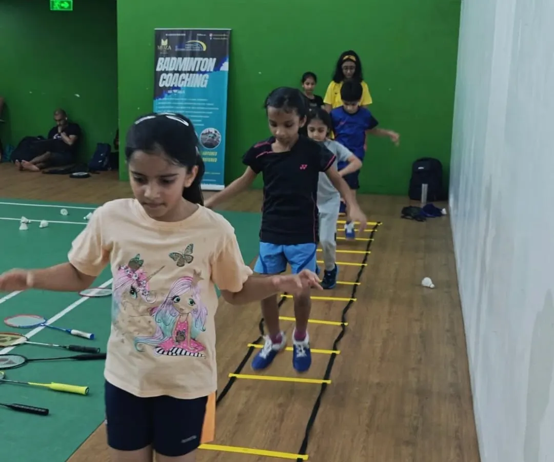 Agility is key in badminton. Here, my young students work on their footwork and coordination using agility ladders, a fun and essential part of our fitness routine for kids.