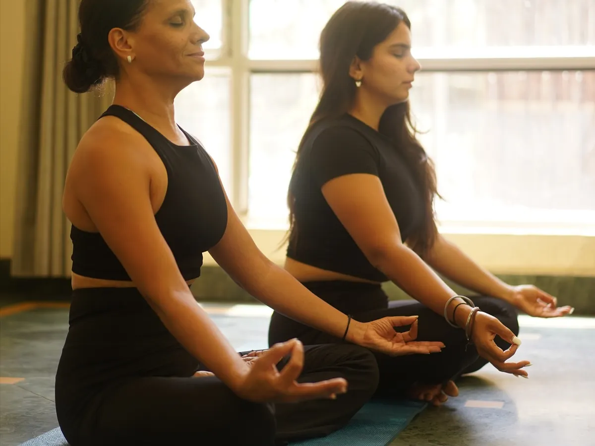 Our practice is a shared journey. Here we are, mother and daughter, in a moment of quiet meditation. We bring this same sense of peace and centeredness to every session we teach, helping your team connect with their inner stillness amidst a busy workday.