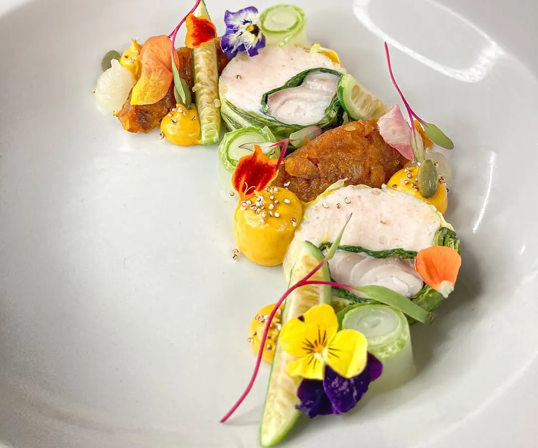 A dish that is as vibrant as it is flavorful. This Ballotine of fish is wrapped in Swiss Chard with a shrimp mousseline, complemented by yuzu pumpkin and pickles. It’s a perfect example of my approach to fine French cooking.