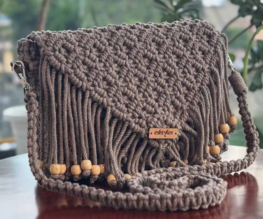 My boho-style fringed sling bag is one of my most popular designs. I make it with soft, eco-friendly cotton cord, and it's perfect for adding a touch of handmade charm to any outfit. This beautiful brown shade is a classic.