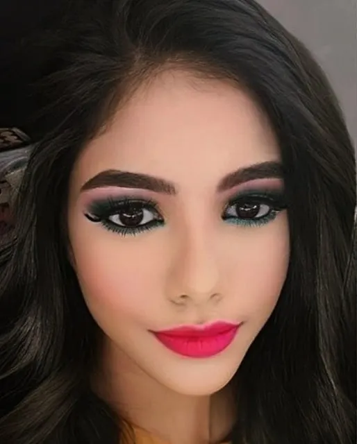 A close up on a bold party look. I created this dramatic eye with a sharp wing and blended liner, paired with a vibrant fuchsia lip to show my skill in creating sharp, impactful makeup that is perfect for evening events.