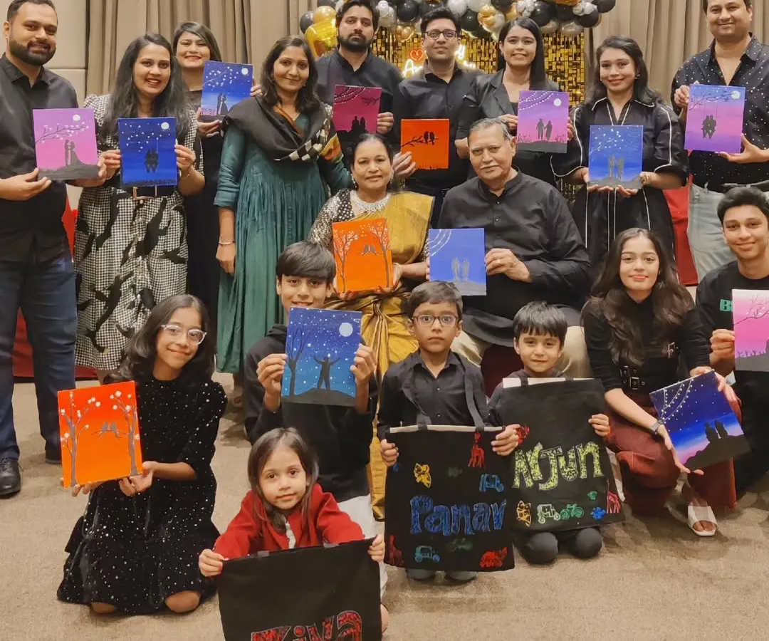 Art has a beautiful way of connecting generations. For this family's 50th wedding anniversary, everyone from grandparents to grandchildren painted together. They created silhouette canvases and personalized tote bags, turning a milestone celebration into a shared creative memory.