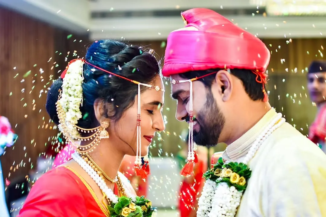 The sacred Akshata ceremony, a pivotal moment in a Marathi wedding. We capture the emotion as the couple showers each other with blessed rice, symbolizing prosperity and happiness.