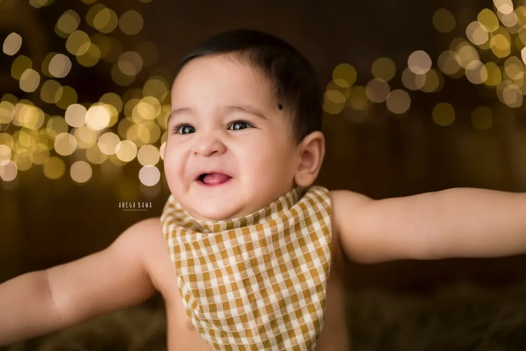That pure, uncontainable joy. This is the kind of smile that lights up a room, and it's my absolute favorite thing to capture during a milestone baby photography session. A close-up portrait like this freezes a moment of pure happiness.