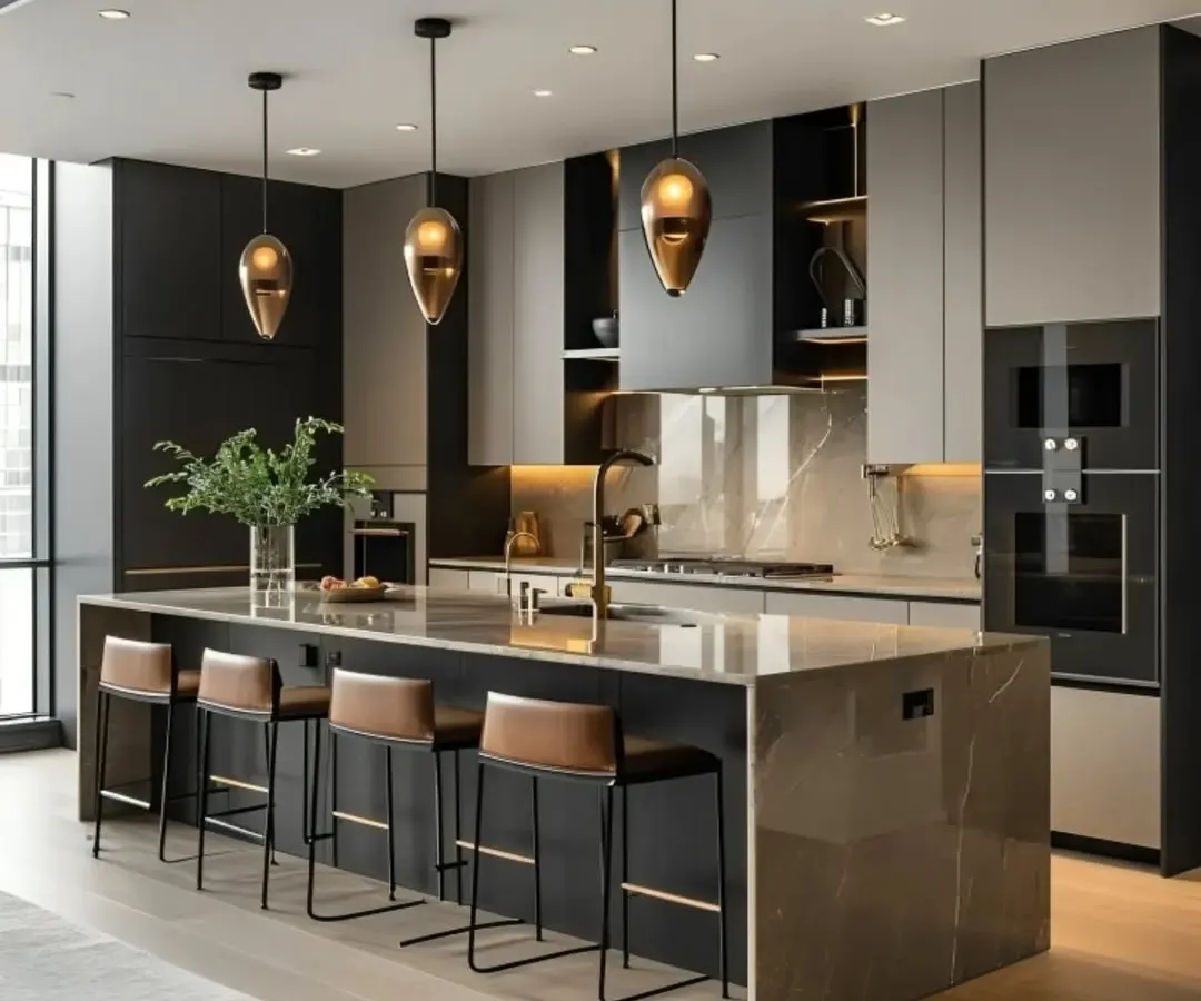 A showcase of a high-end modern kitchen, featuring a marble waterfall island with a breakfast bar. The design combines dark cabinetry with integrated appliances and warm pendant lighting, creating a perfect space for both cooking and socializing.