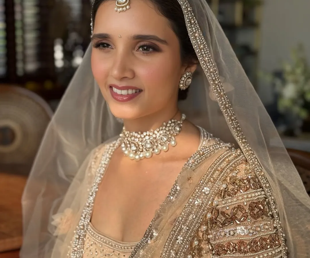 For this bride's Anand Karaj ceremony, we chose a soft, ethereal makeup look. The focus was on fresh, glowing skin and subtly defined eyes, perfectly matching the delicate pastel tones of her Tarun Tahiliani outfit. This is an example of minimal magic, enhancing natural beauty.