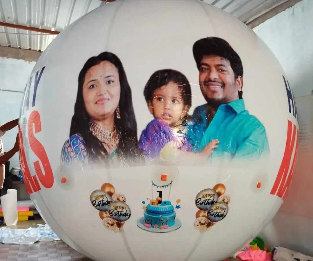 I print your favorite photos directly onto large, white, round balloons. This example shows a full-color family portrait for a first birthday celebration, demonstrating the clarity and scale of the final product. It's a great way to make personal events memorable.