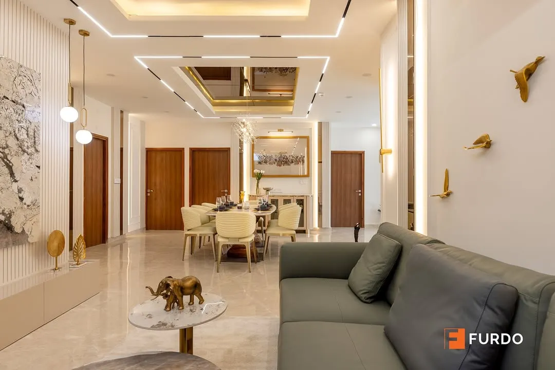 A closer look at the open-plan living space, highlighting the seamless flow into the dining area. Notice the custom wall paneling, statement art, and elegant furniture that combine to create a cohesive and inviting environment for family and guests.