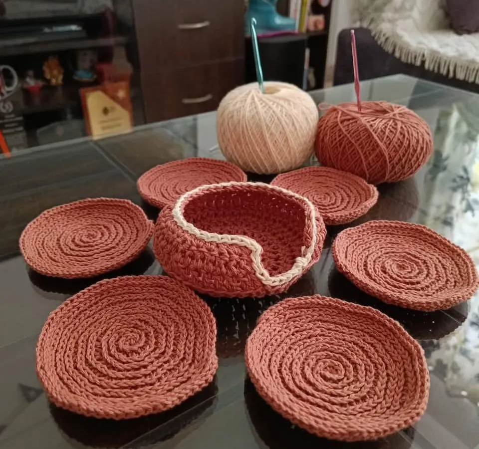 This is my handmade coaster set, made with high quality cotton yarn. It comes with six coasters and a little basket to keep them in. This rustic brown color looks very nice on the table. 😇