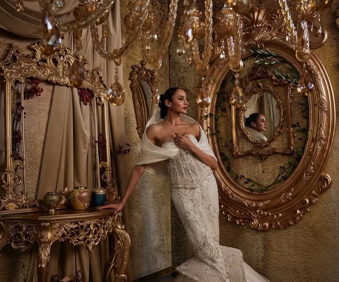 In this ivory gown, I explored the contrast between a corseted, fit-and-flare silhouette and the soft power of a dramatic hooded panel. The hand embellishments are meticulously placed to catch the light, creating a piece that feels both intentional and unforgettable, perfect for a modern bride.