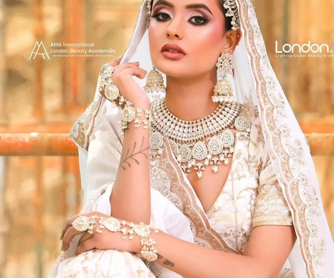 For the bride who loves elegance and grace, this all-white lehenga with intricate pearl and thread work is a dream. The matching jewellery set completes a look that is both modern and ethereal, perfect for a day wedding or reception.