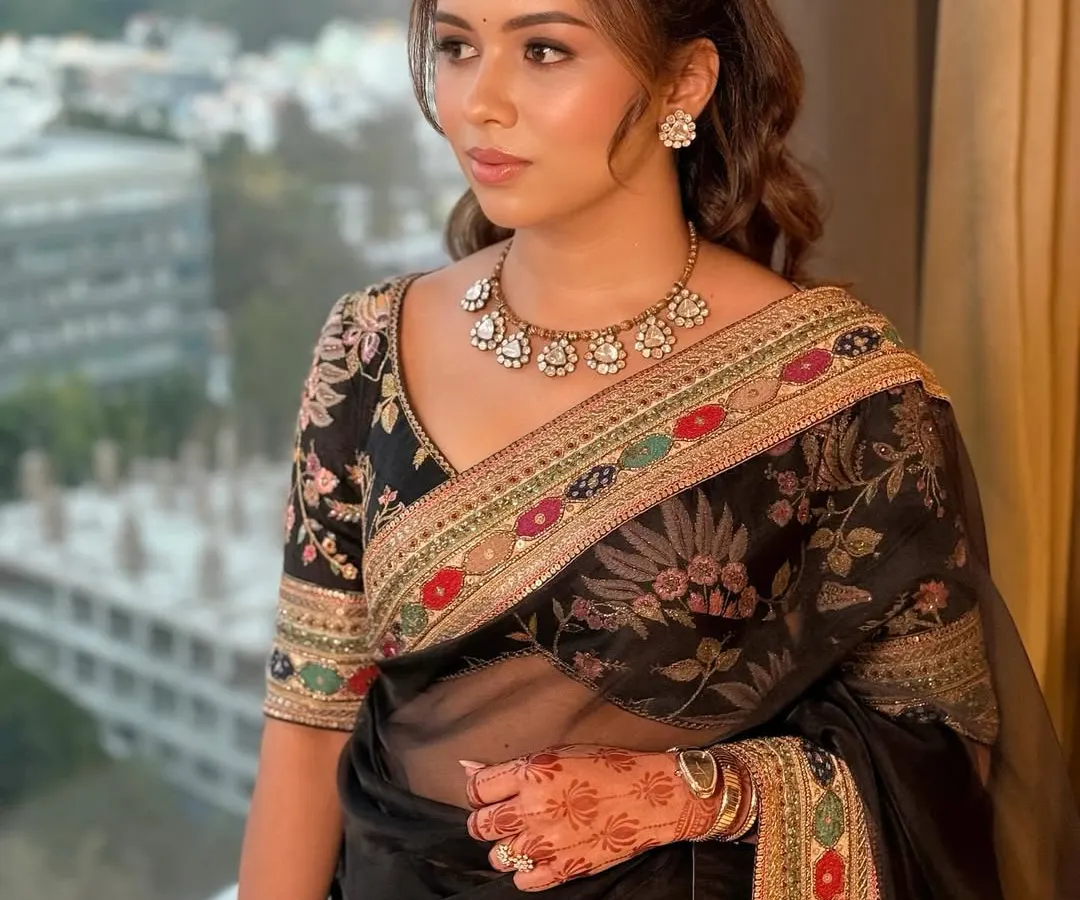 This client is the picture of timeless luxury in a classic black Sabyasachi saree. I created a soft glam look with dewy, glowing skin and gentle waves in her hair to complement the intricate floral embroidery of her outfit, perfect for an elegant evening affair.
