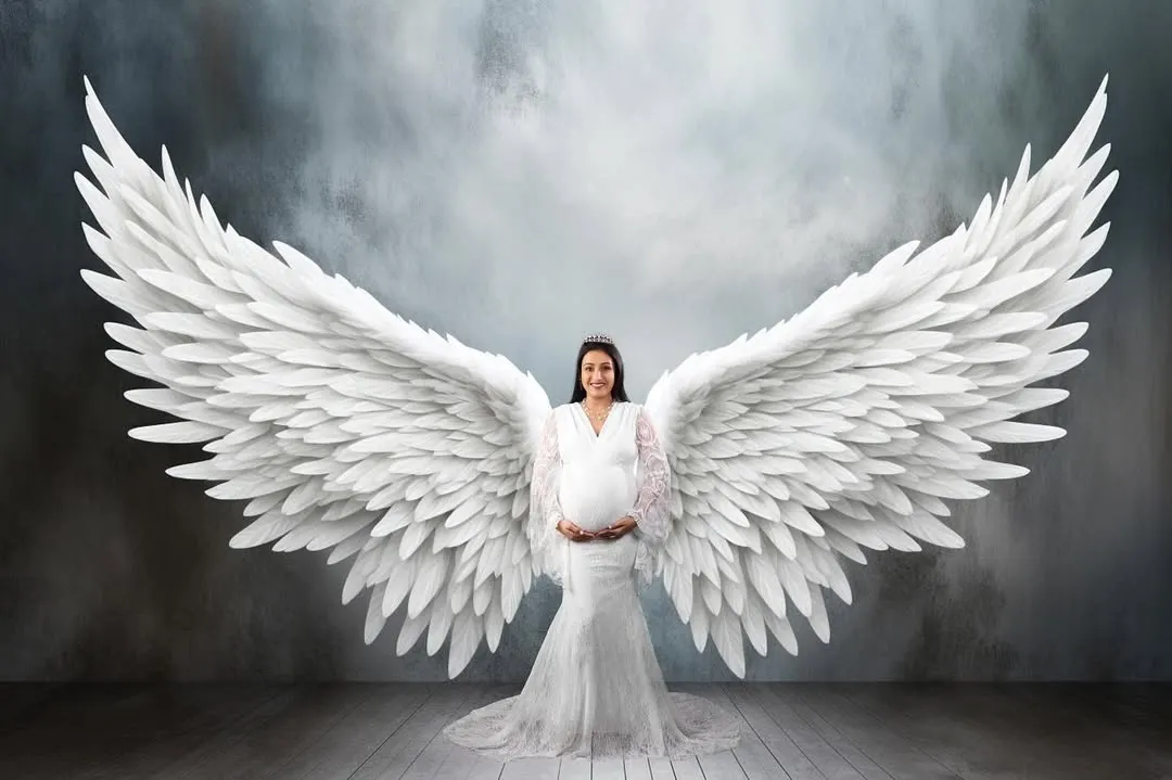 For a truly magical memory, I create fine art portraits like this one. With beautiful angel wings and dramatic lighting, I can turn your maternity photo into a breathtaking piece of art that feels truly special.