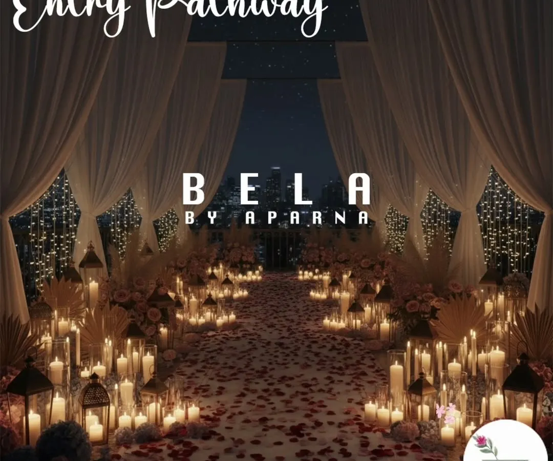 I design dramatic entryways that build anticipation for the big moment. This pathway is lined with a sea of candles in glass holders and scattered rose petals, leading to the main event space.