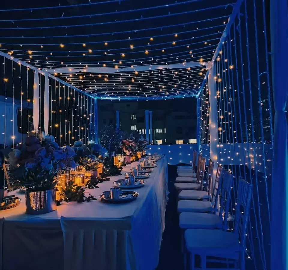 We can transform any space into an elegant setting, like this intimate rooftop dinner. A canopy of fairy lights and deep blue ambient lighting created a magical atmosphere for a special corporate gathering.