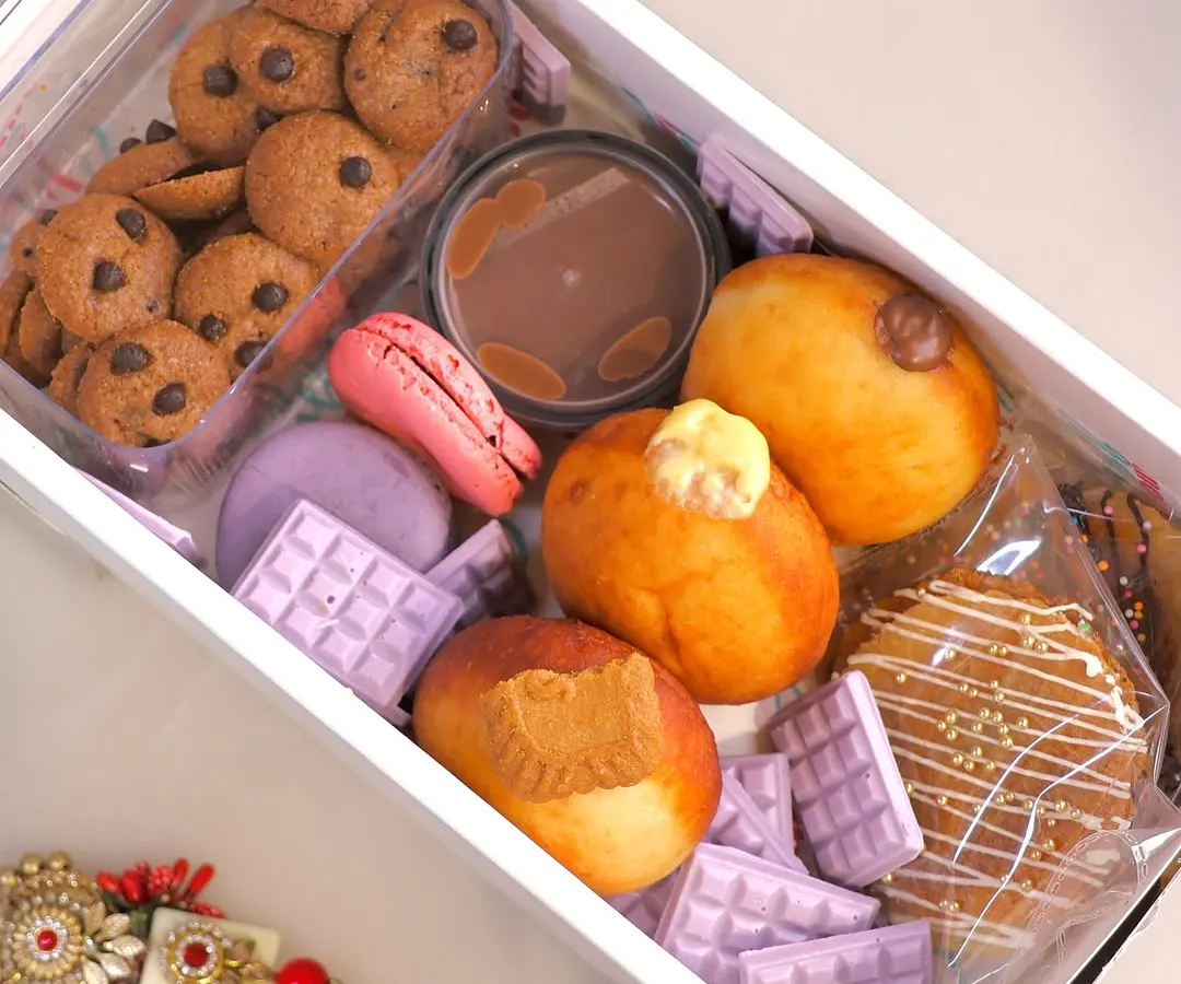 This is our limited edition Grazing Box, a perfect example of how we pack joy and indulgence for your special occasions. It includes a variety of our freshly made, 100% eggless delights like assorted bombolinis, cookie cereal, macarons, and stroopwafels, all ready to be shared.