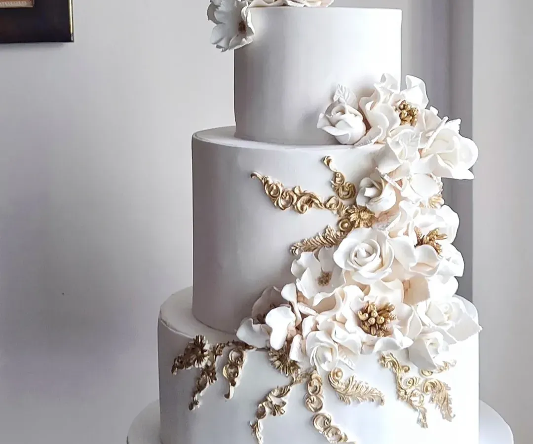For me, a wedding cake should be pure elegance. This three-tiered beauty features a cascade of handcrafted white and gold sugar flowers, creating a timeless and sophisticated centerpiece. It’s a testament to how classic design can make the most powerful statement on your special day.