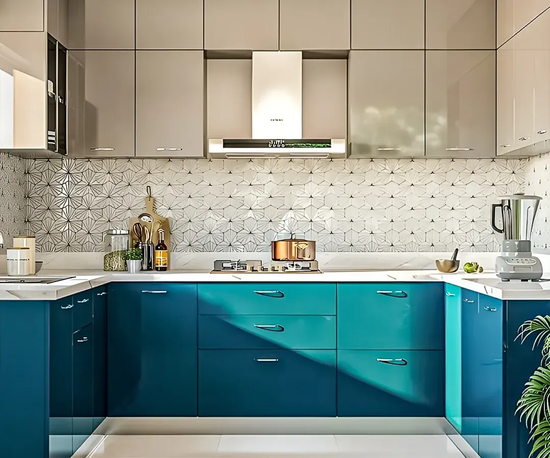 A vibrant and contemporary U-shaped modular kitchen. The dual-tone design pairs glossy teal base cabinets with sleek grey overhead units, complemented by a striking geometric backsplash tile and a clean white countertop, making it a perfect example of modern kitchen interiors.