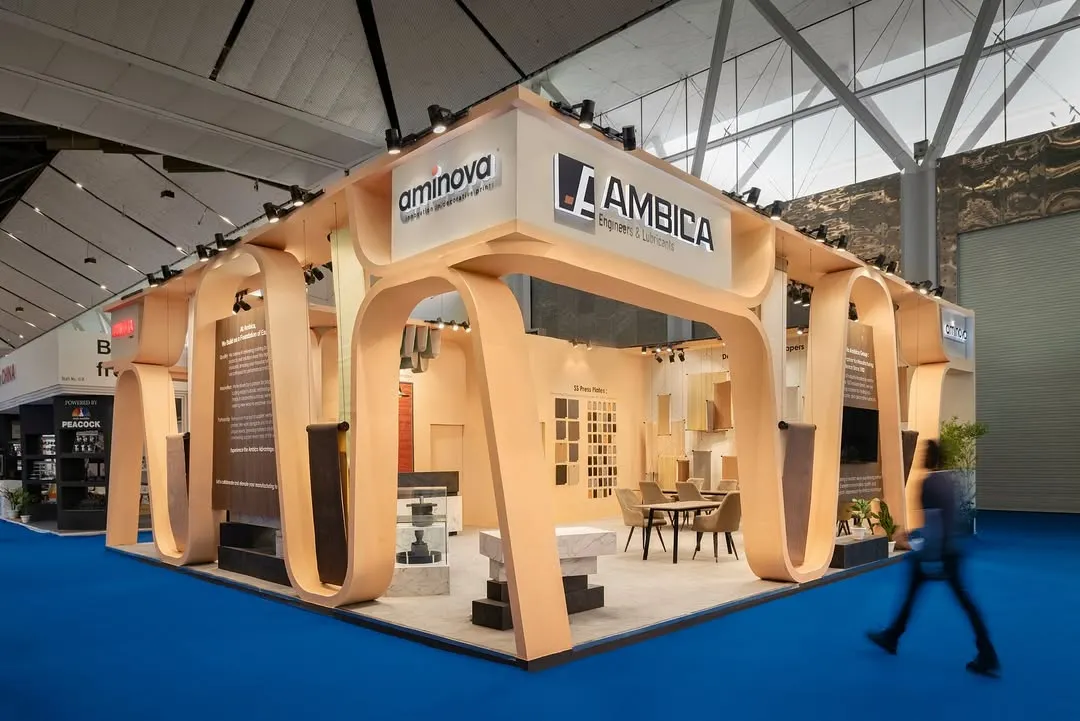 The design for Ambica's 110 sq.m exhibition stall was inspired by the rhythmic motion of a conveyor belt. We translated this industrial aesthetic into an elegant architectural form, with waves rippling around the fascia to suggest dynamic movement.