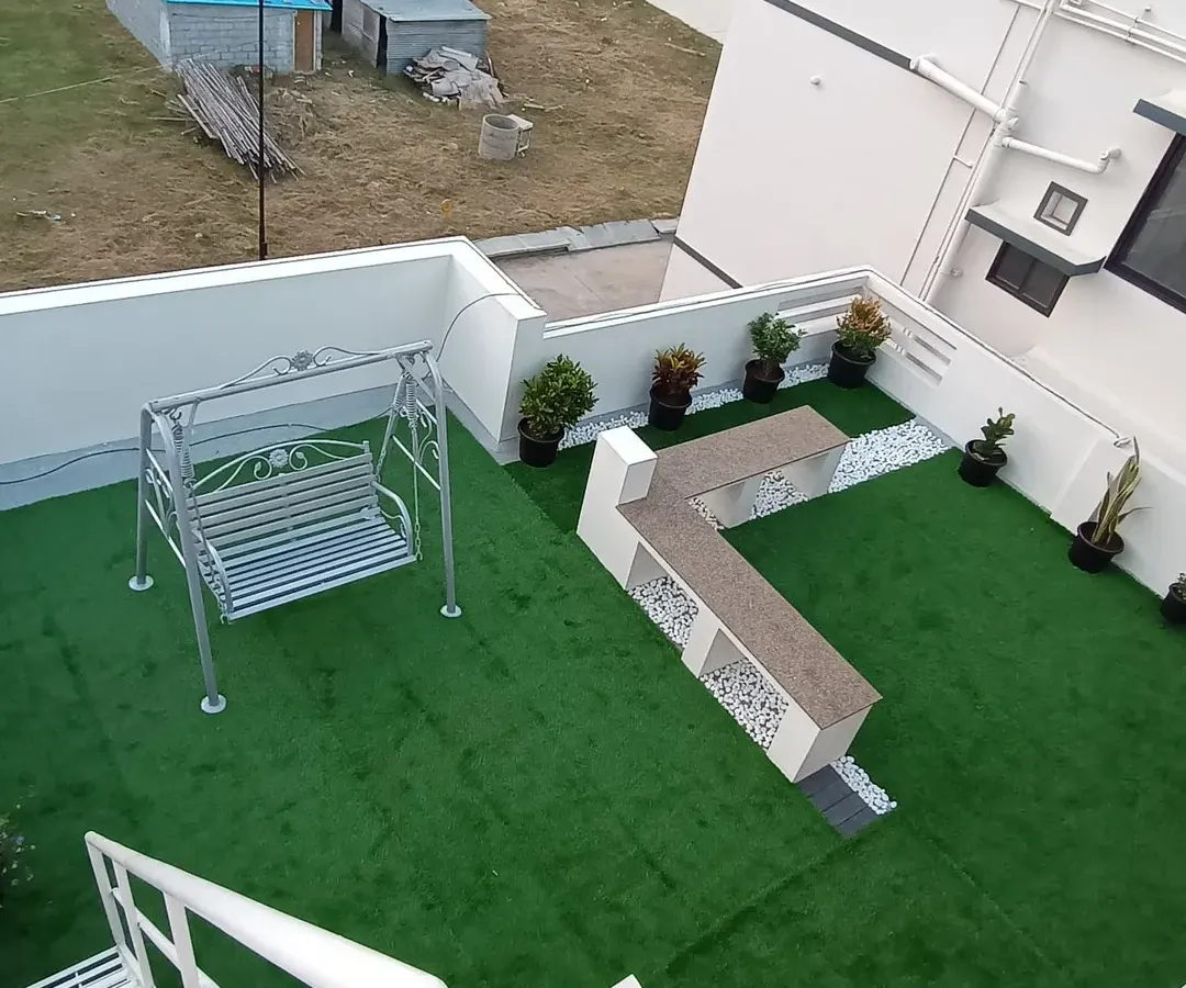This is a complete rooftop transformation I completed, turning a bare terrace into a beautiful garden lounge. The project included installing pet-friendly artificial turf, a custom seating area, and a swing for relaxation.