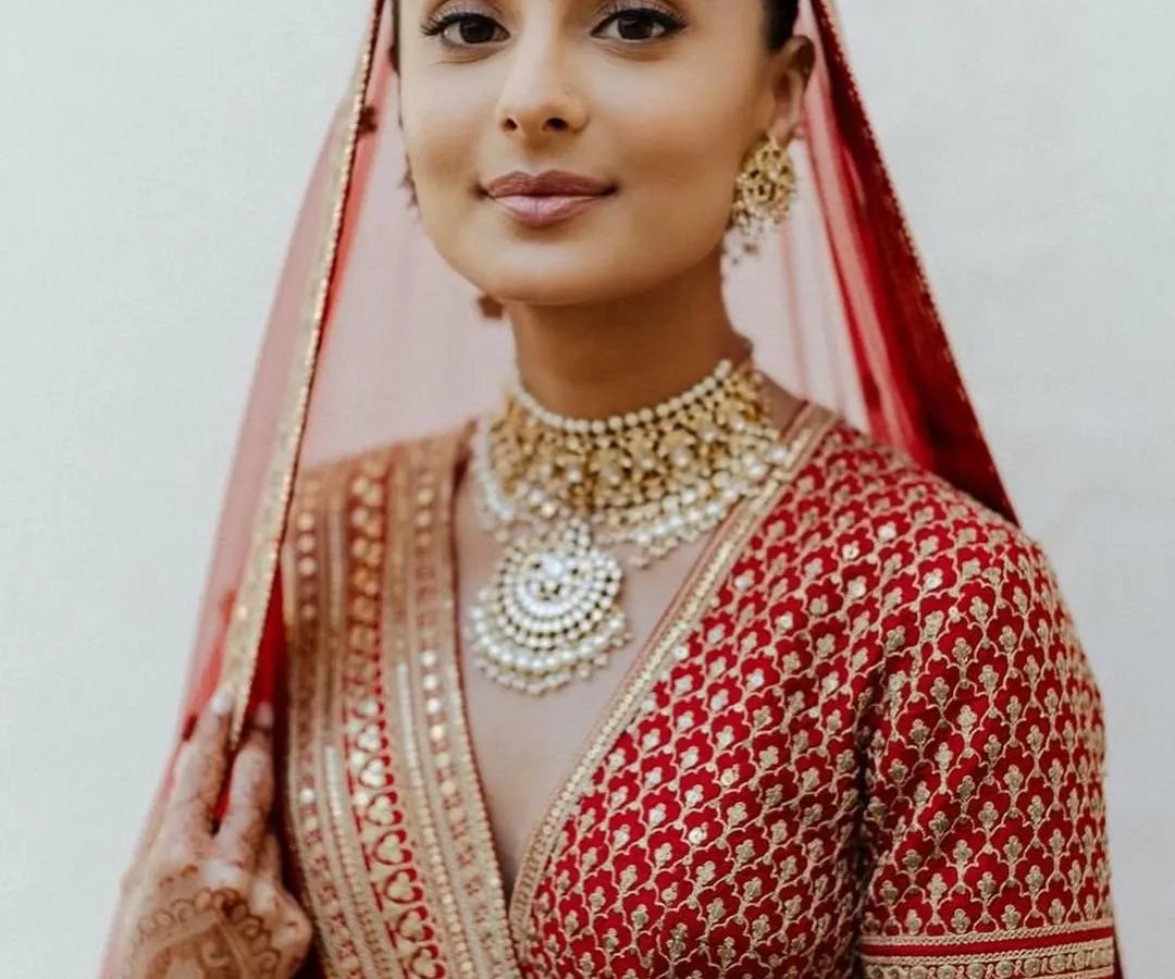 A classic red bridal look will never go out of style. For this bride, I created a soft glam look with defined eyes and a neutral lip, ensuring her natural beauty was the focus. This timeless makeup is perfect for the main wedding ceremony.
