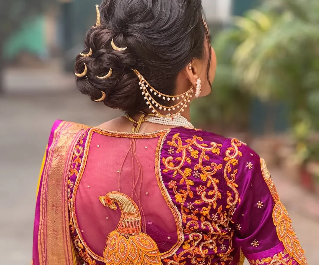 For my Maharashtrian brides, I create authentic and regal looks like this intricate bridal bun. The highlight is the traditional chandrakor accessory, which I place carefully to complement the textured updo and the stunning details of the Paithani saree. This style is all about honoring tradition with grace.