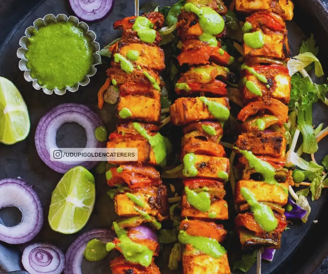 Vibrant Paneer Tikka skewers, grilled to perfection. We marinate soft paneer cubes and fresh vegetables in aromatic spices, then grill them live at your event, delivering a smoky, delicious appetizer that is always a crowd favorite.