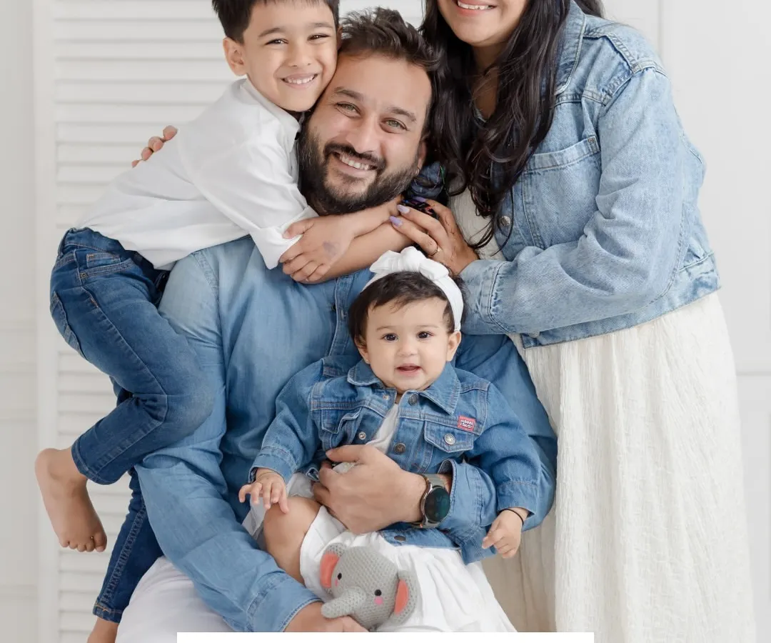 A classic family portrait is more than just a photo; it's a feeling. The pure, unscripted joy of the Baliya family, all dressed in classic denim and white, is a perfect example of the timeless memories we capture in the studio.