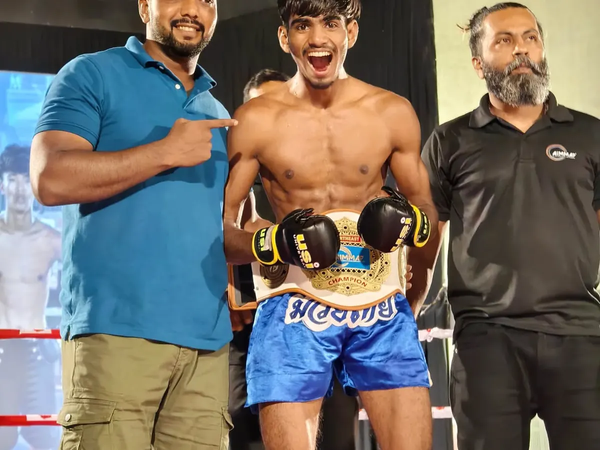 This is what we train for. One of my fighters holding the AIMMAF title belt after a hard-earned victory in Siliguri. I don't just train you; I am in your corner on fight night, guiding you to the win.