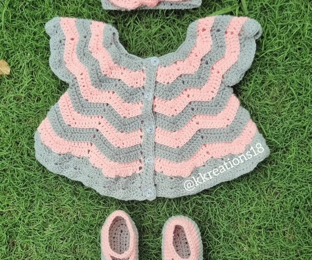 This is one of my favorite creations, a complete baby frock set in soft pink and grey. It includes a chevron-patterned dress, matching little booties, and a sweet bow headband. It’s a perfect, heartfelt gift for a baby shower or a newborn's first outfit.