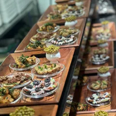 A multi-tiered display of assorted appetizers. Using vertical space not only looks impressive but also allows guests to easily see and access the variety of food on offer.