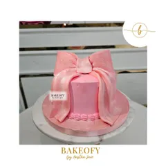 Indulge in elegance with this stunning pink bow cake. The velvet-textured fondant bow makes a beautiful statement on this simple, chic cake.