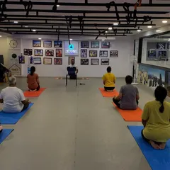 Leading a group meditation for corporate clients at the HITYOGA studio. The space is designed to be a peaceful escape, allowing employees to fully immerse themselves in the practice of stress relief and mindfulness.