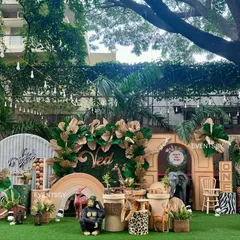 I created a boho-chic 'Wild One' jungle theme using a palette of earthy tones, dried palm leaves, and large animal props for a stylish and immersive first birthday celebration.